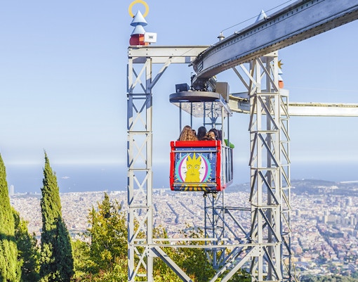 Tibidabo amusement park ride with city view in Barcelona.