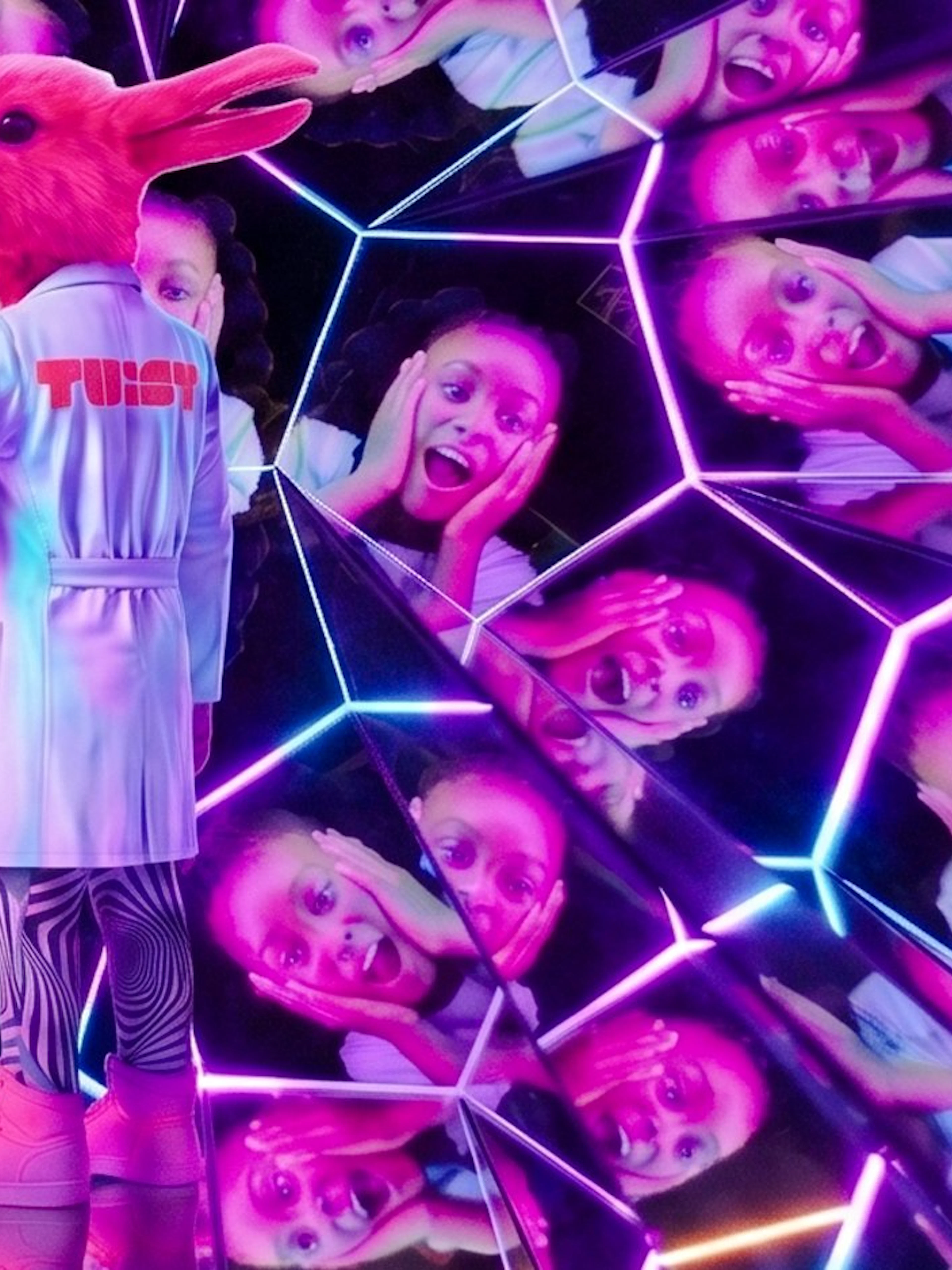 Guest in a rabbit costume at Twist Museum London, surrounded by mirrored reflections.