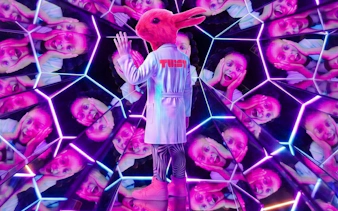 Guest in a rabbit costume at Twist Museum London, surrounded by mirrored reflections.