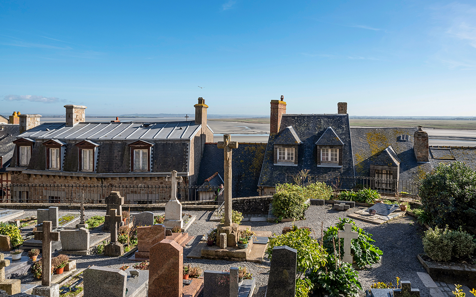 Rooftop view of Mont-Saint-Michel Abbey with surrounding landscape.