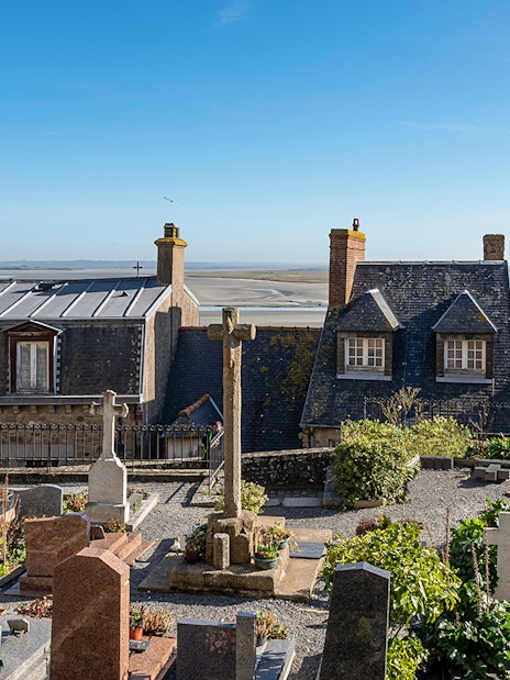 Rooftop view of Mont-Saint-Michel Abbey with surrounding landscape.