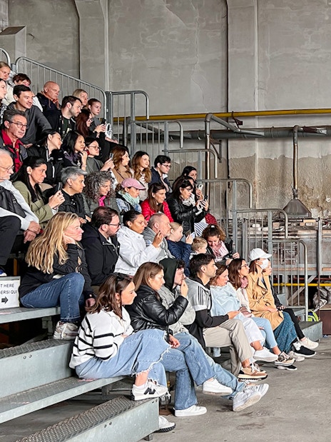 Visitors watching a glassblowing demonstration at a Murano glass factory.