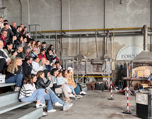 Murano islands water canal with boats and colorful traditional buildings in Venetian Lagoon.