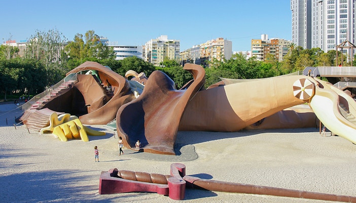 Gulliver Park playground in Valencia with giant sculpture slides and children playing.