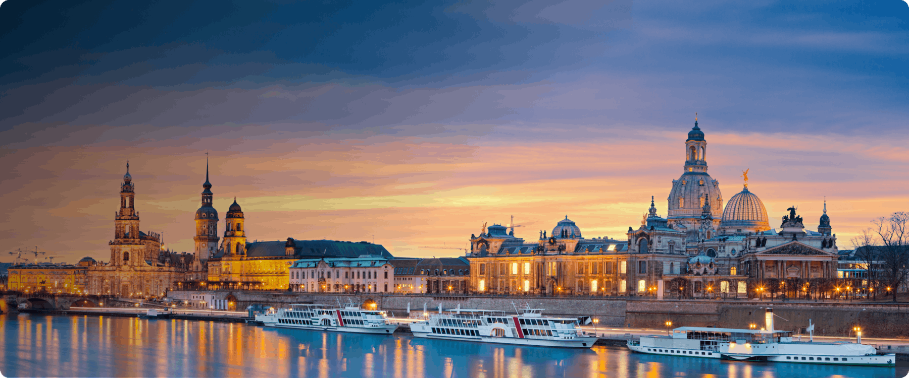 Dresden skyline at sunset with historic buildings and Elbe River boats.