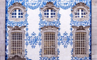 Blue and white azulejo tiles on a historic building facade in Porto, Portugal.