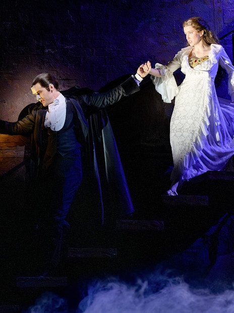 Phantom leads Christine down stairs in Vienna's "The Phantom of the Opera" musical scene.