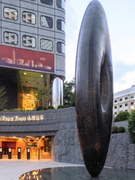 Entrance to The Peak Tram with modern sculpture in Hong Kong.