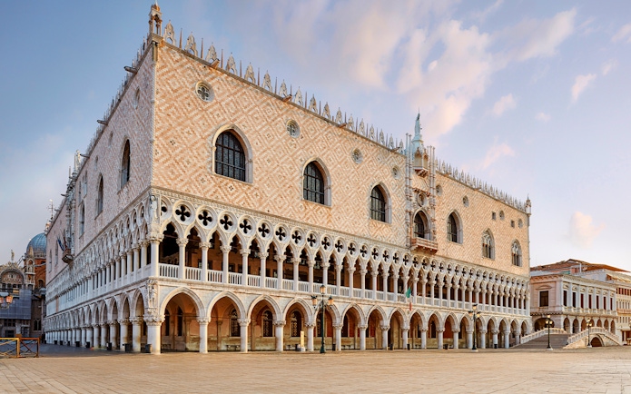 Doges Palace in Venice with Gothic architecture and arched colonnades.