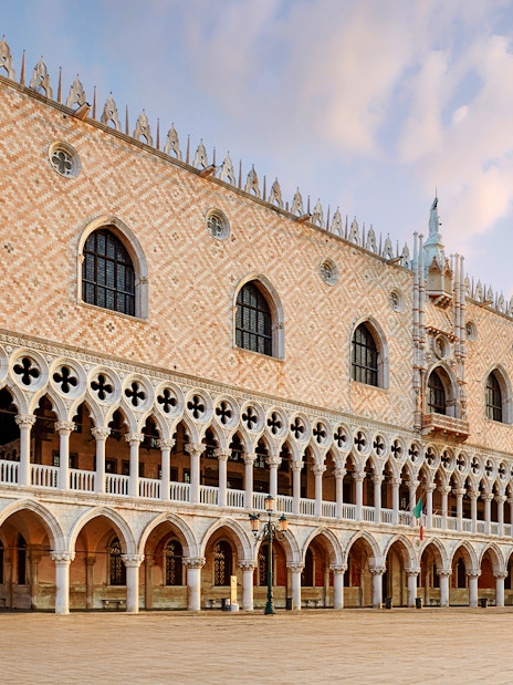 Doges Palace in Venice with Gothic architecture and arched colonnades.