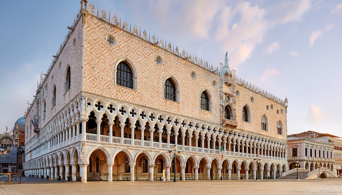 Doges Palace in Venice with Gothic architecture and arched colonnades.