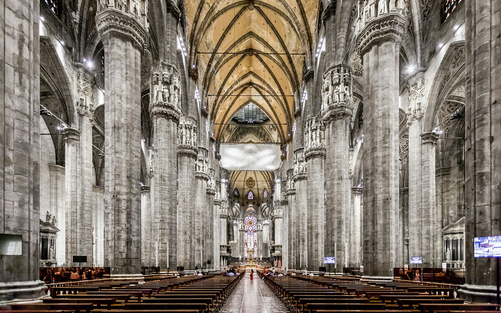 Duomo Cathedral Milan interior with ornate columns and detailed ceiling.