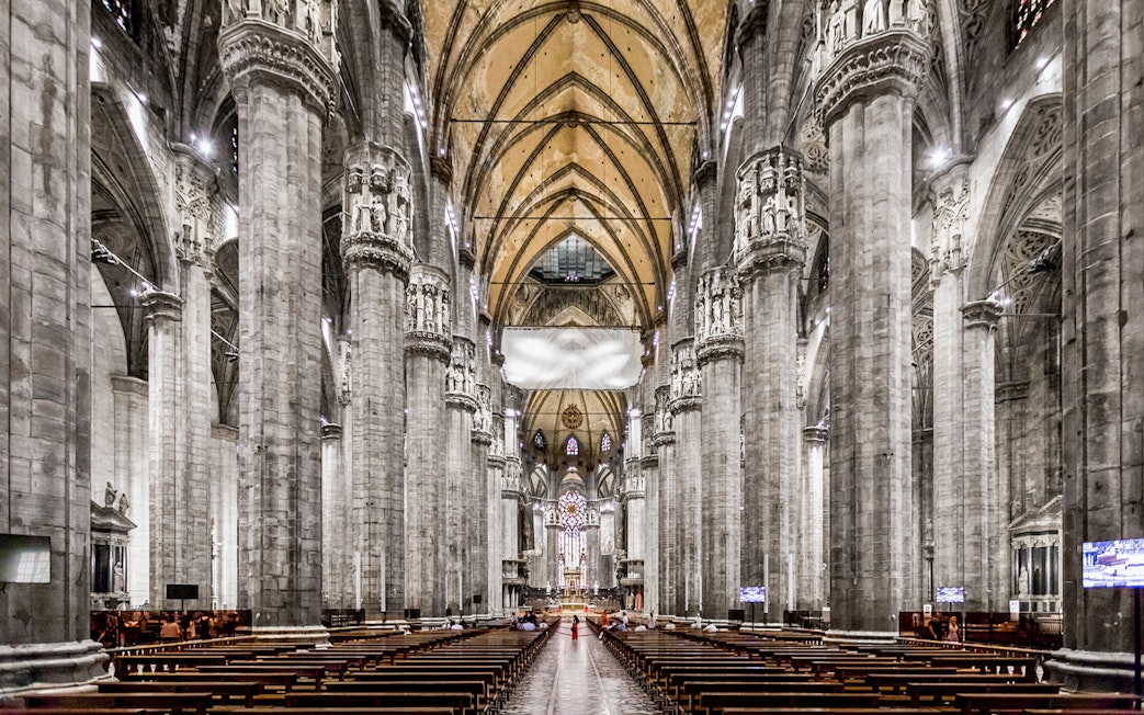 Duomo Cathedral Milan interior with ornate columns and detailed ceiling.