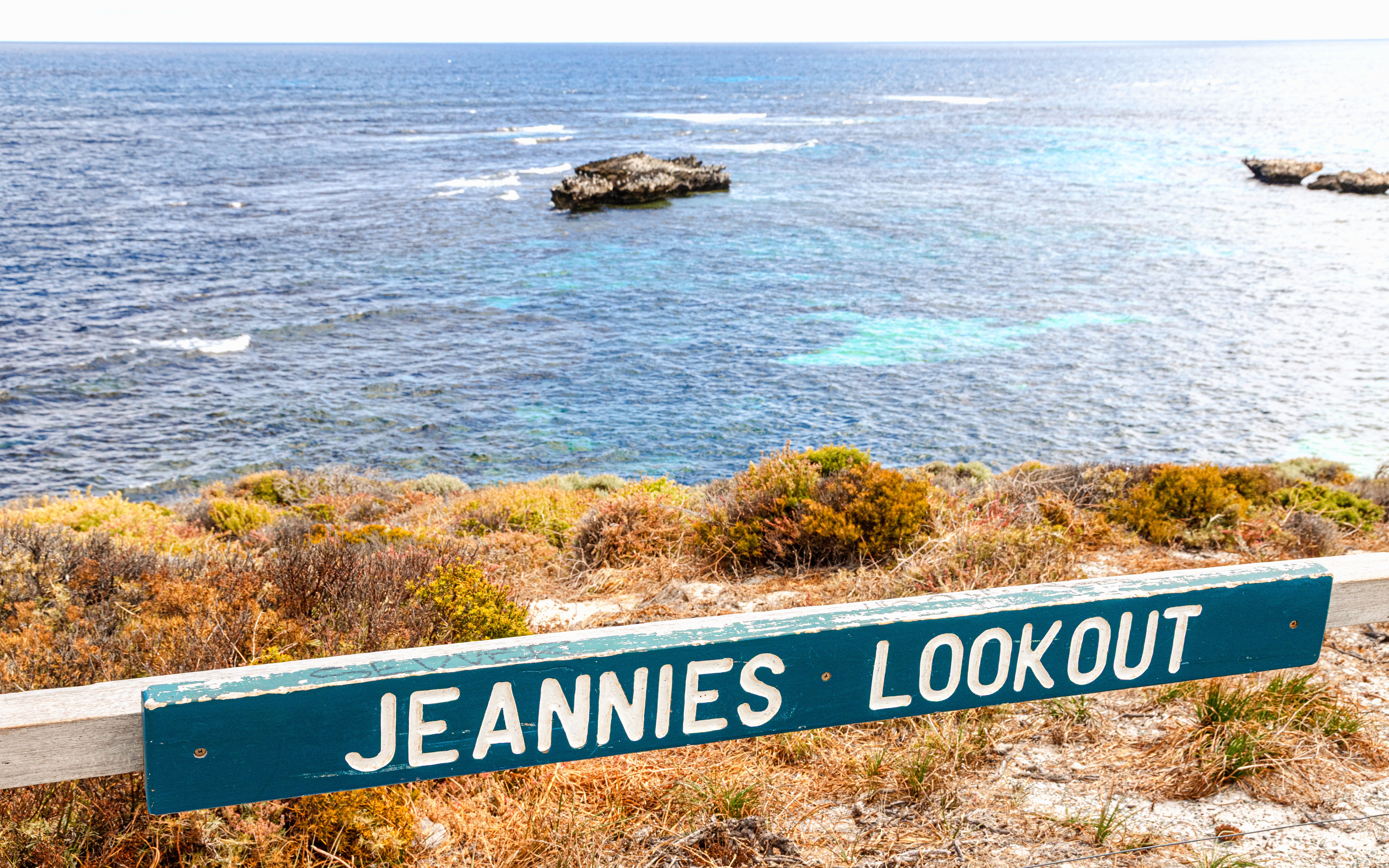 Jeannies Lookout sign with view of Indian Ocean at Wadjemup, Rottnest Island.