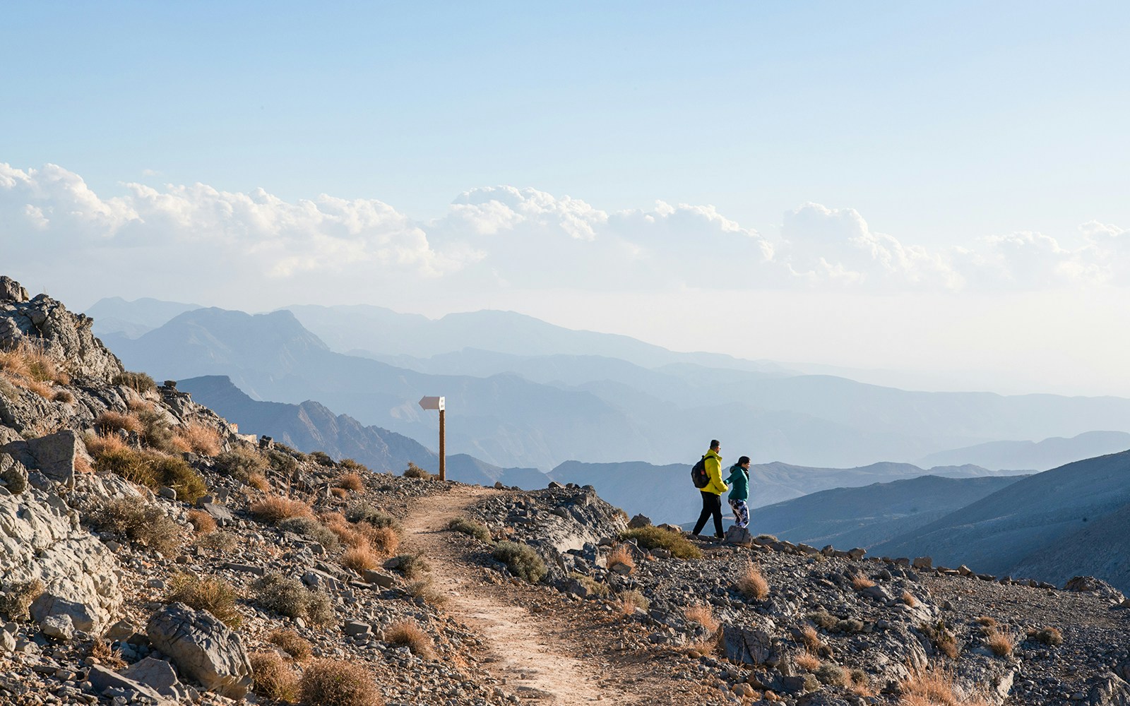 Hikers on Jebel Jais trail in UAE mountains.