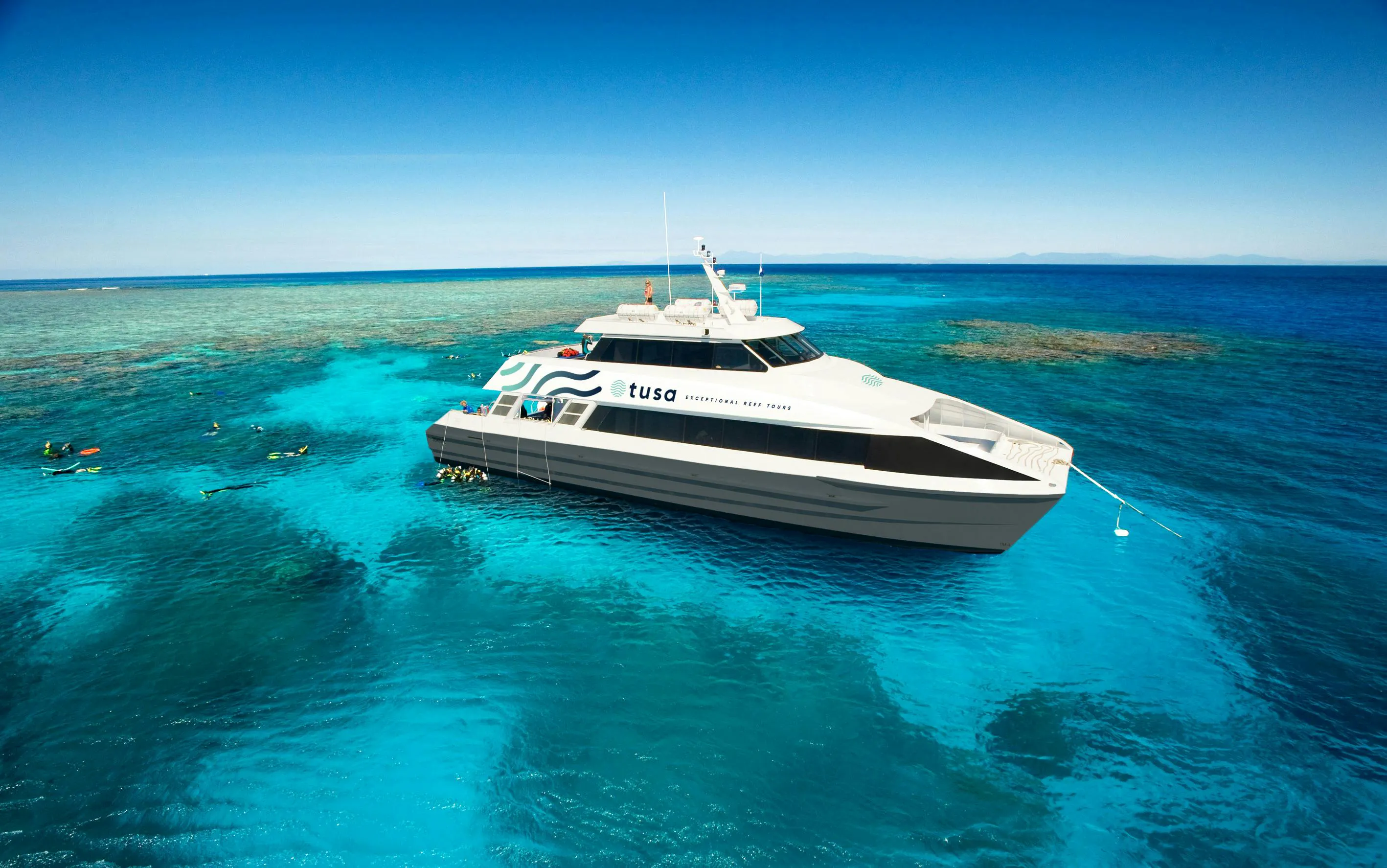 Snorkelers near a tour boat on the Great Barrier Reef, Cairns.