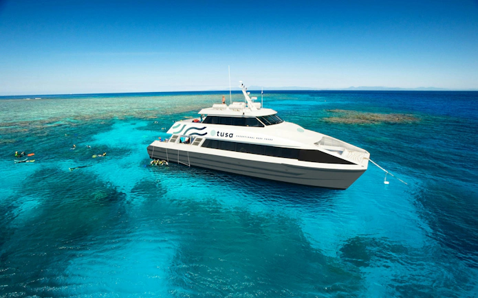 Snorkelers near a tour boat on the Great Barrier Reef, Cairns.