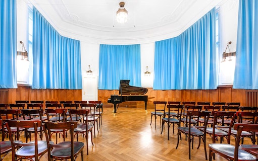 Concert hall with grand piano and seating at Ehrbarsaal, Vienna.