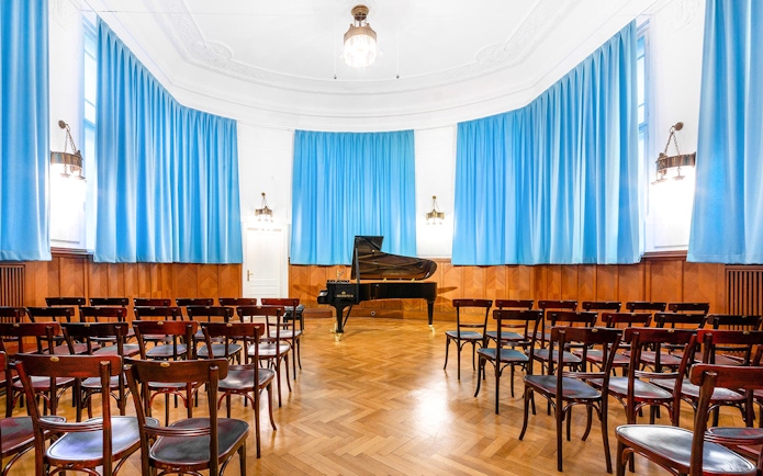 Concert hall with grand piano and seating at Ehrbarsaal, Vienna.