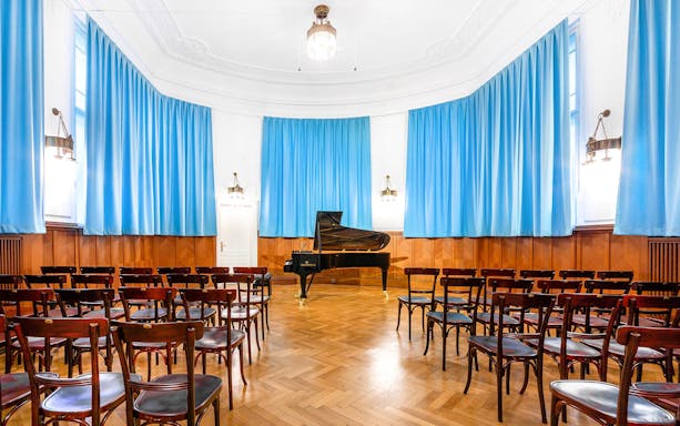 Concert hall with grand piano and seating at Ehrbarsaal, Vienna.