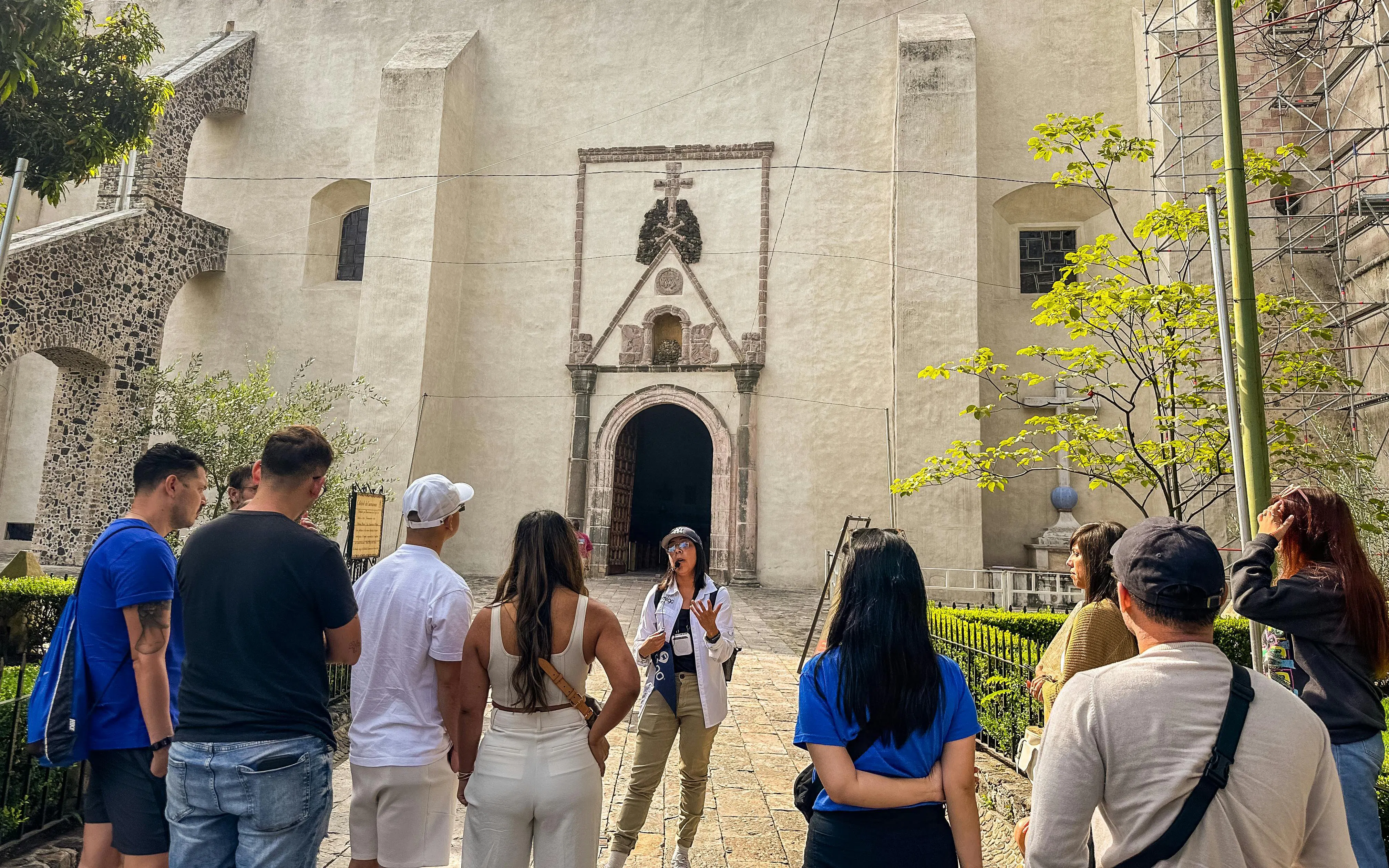 Tour group listening to a guide outside a historic church in Cuernavaca, Mexico City day tour.
