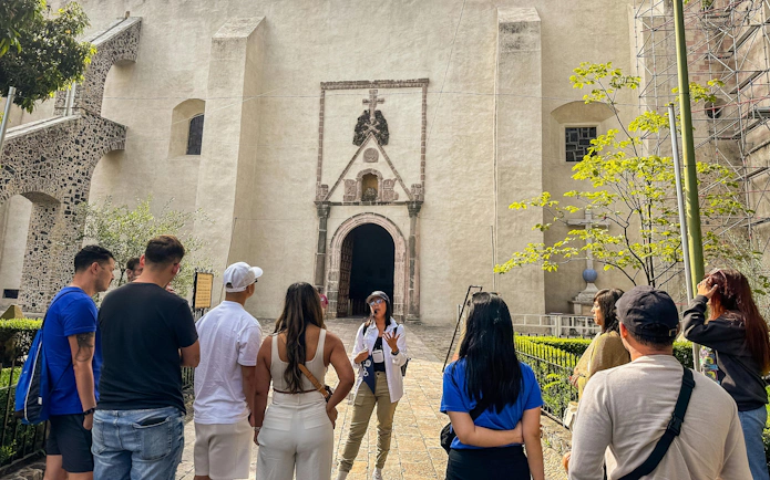 Tour group listening to a guide outside a historic church in Cuernavaca, Mexico City day tour.