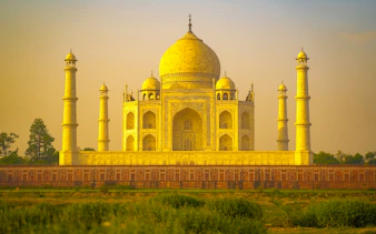 Taj Mahal at sunset during Agra evening tour, viewed from a distance.