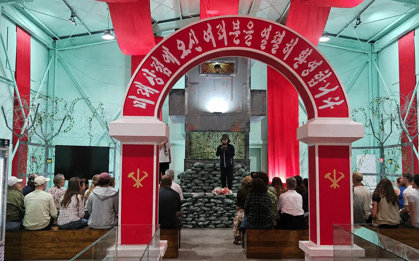 Tour group listening to a guide at a North Korean exhibit during DMZ Premium Small Group Tour.