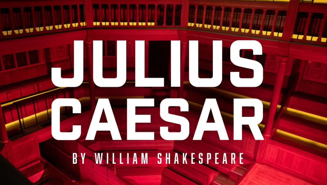 Julius Caesar play title on a theater stage background
