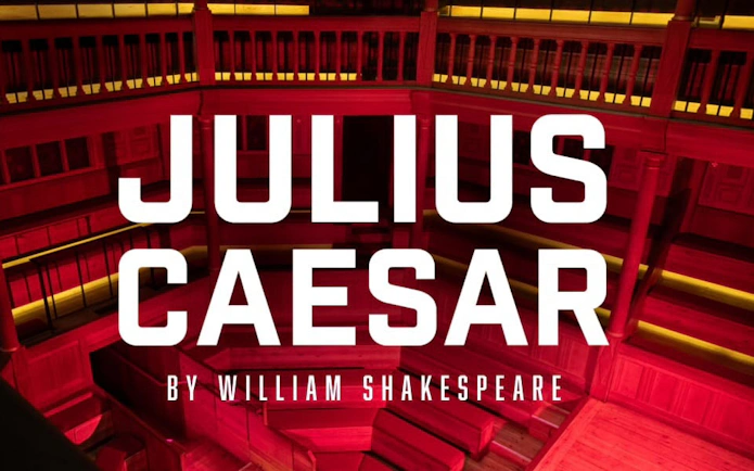 Julius Caesar play title on a theater stage background