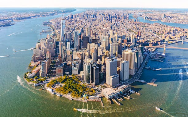 Aerial view of Lower Manhattan, New York City, featuring skyscrapers and waterfront.