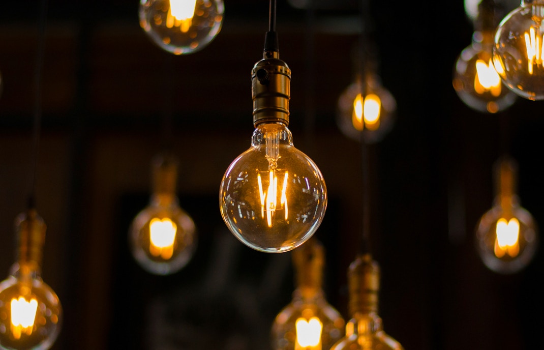 Hanging vintage light bulbs glowing warmly in a dimly lit room.