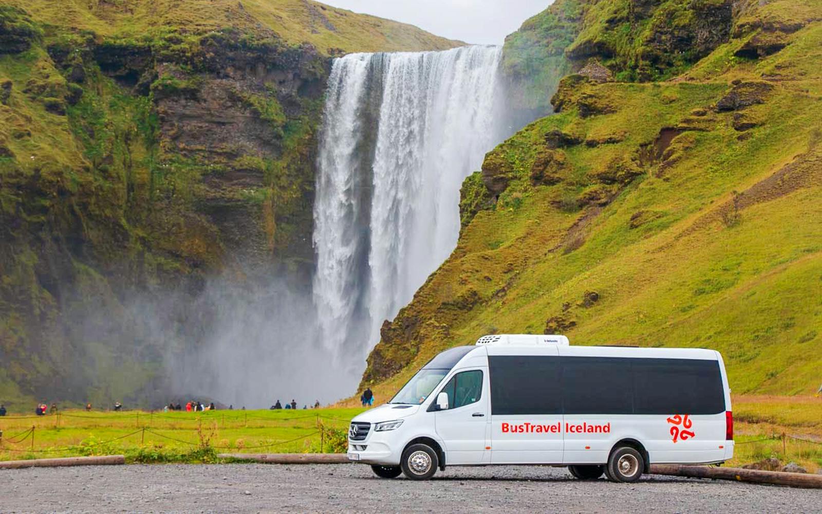 Minivan parked in front of Skogafoss waterfall, South Iceland.