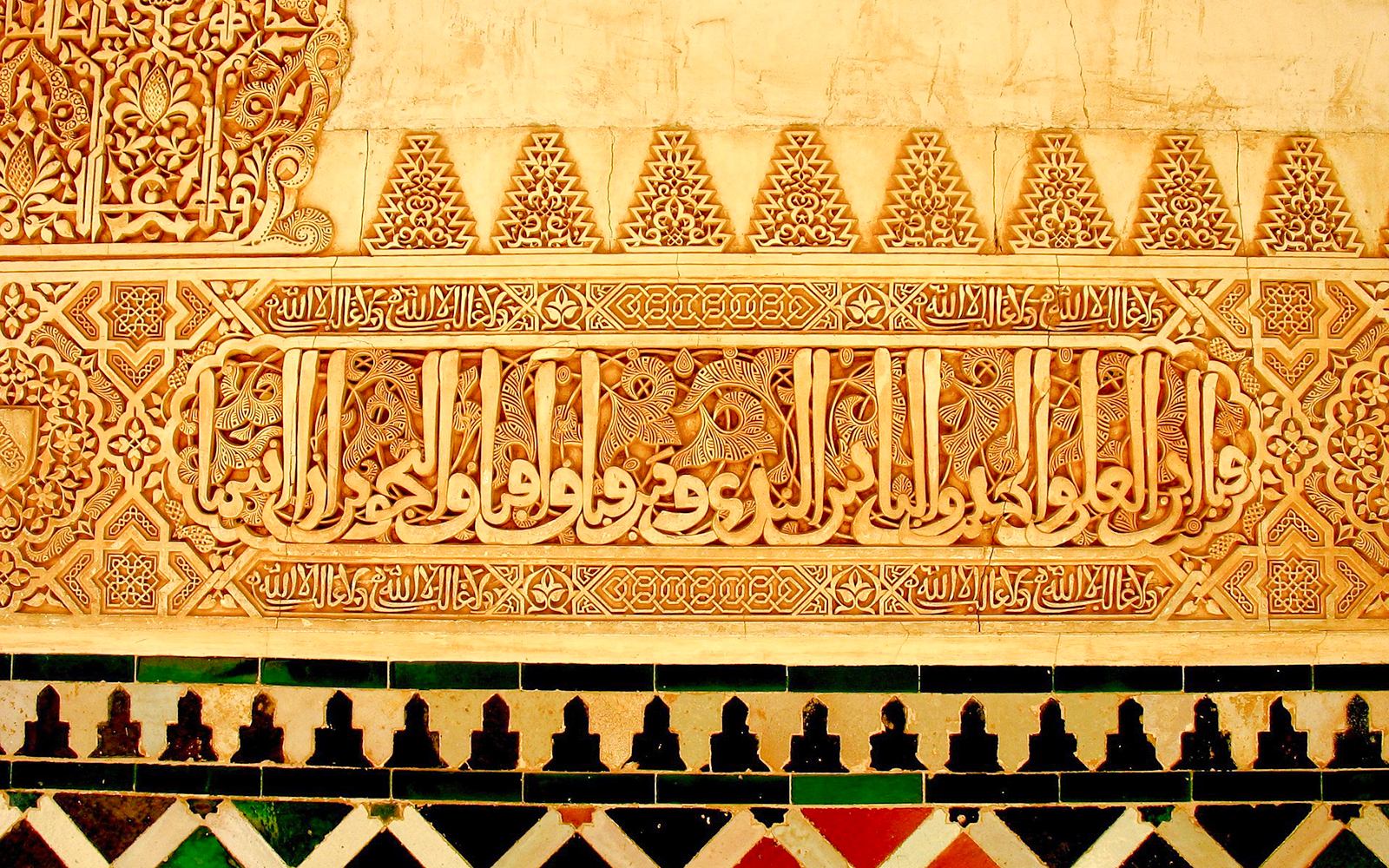 Alhambra's intricate Islamic calligraphy and geometric patterns in Granada, Spain.