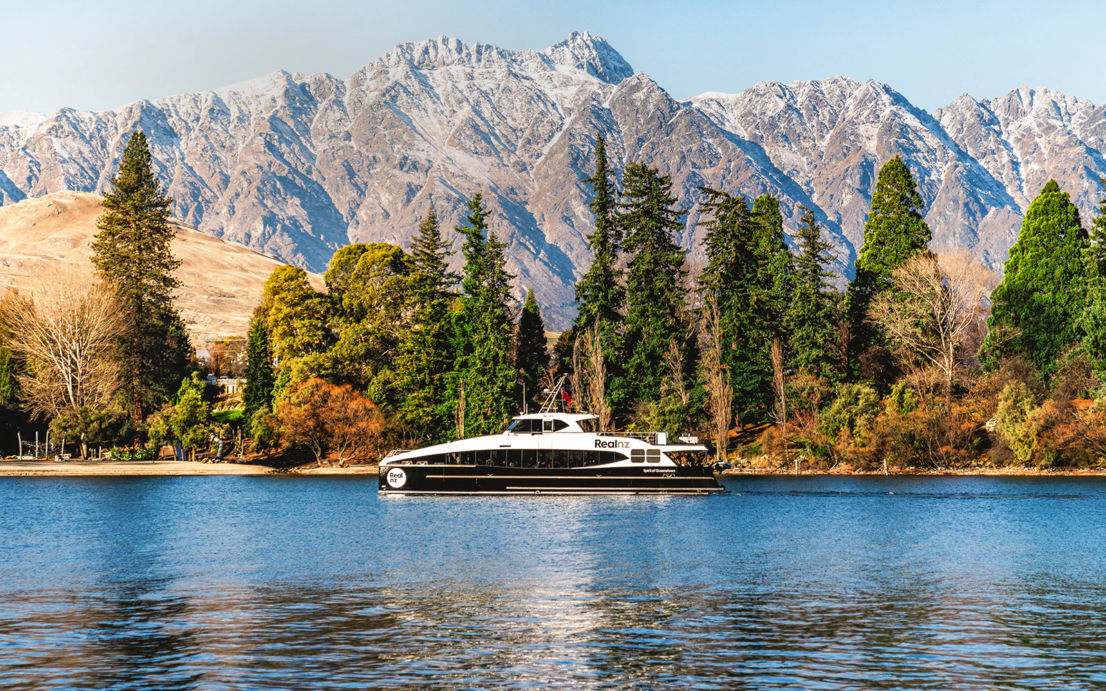 Cruise boat on Lake Wakatipu with Remarkables mountain range, Queenstown.