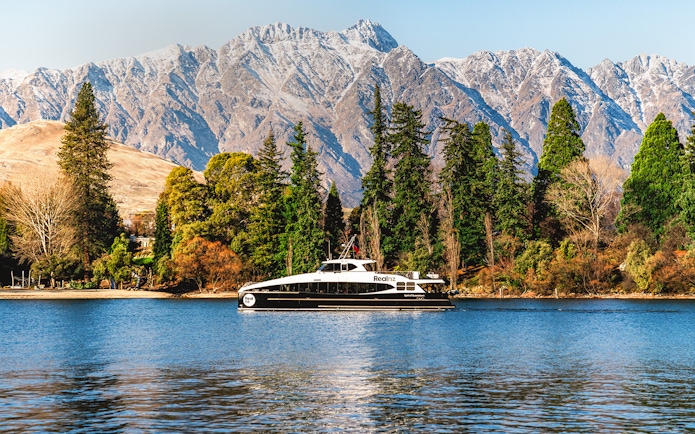Cruise boat on Lake Wakatipu with Remarkables mountain range, Queenstown.