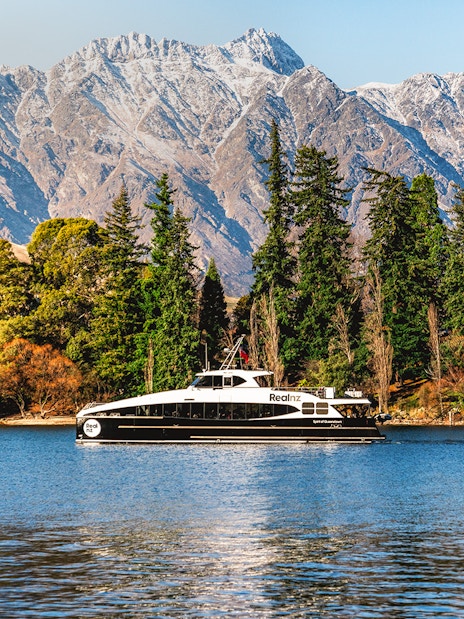 Cruise boat on Lake Wakatipu with Remarkables mountain range, Queenstown.