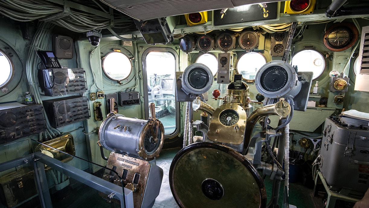 Control room of Submarine Growler at Intrepid Museum, featuring navigation instruments and gauges.