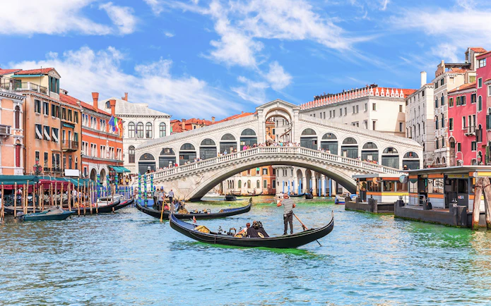 Gondolas on the Grand Canal near the Rialto Bridge in Venice.