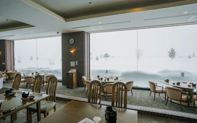Dining area with large windows overlooking snowy landscape, Sapporo to Bibai Snow Land tour, Hokkaido.