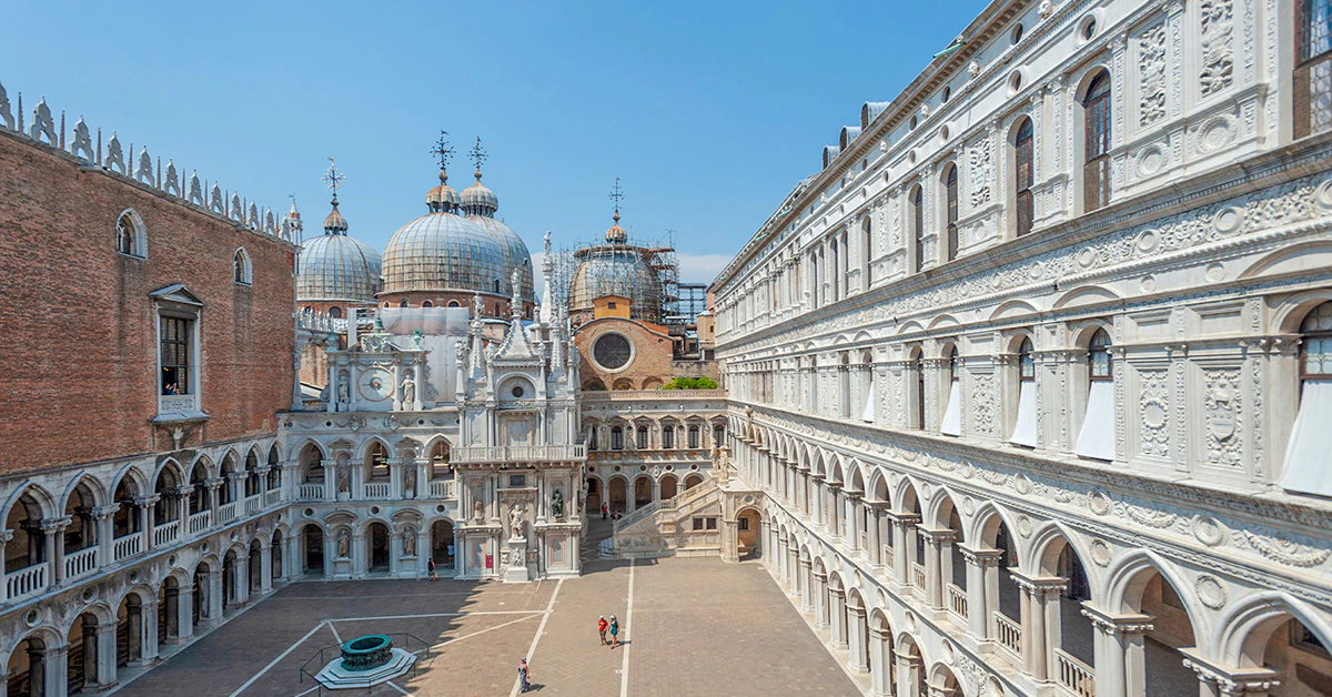 Exterior view of Doge's Palace courtyard and domes in Venice, Italy.