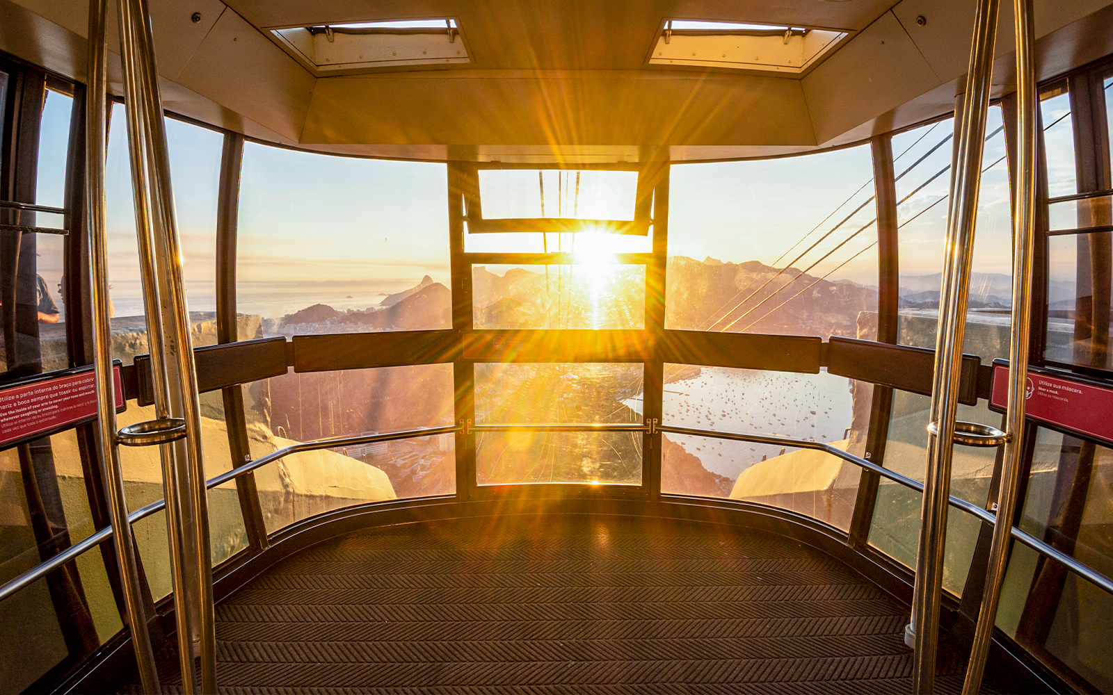 View of Rio de Janeiro from inside Sugar Loaf Mountain cable car at sunset.
