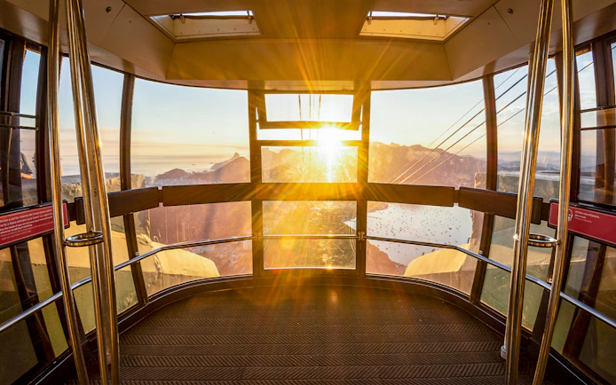 View of Rio de Janeiro from inside Sugar Loaf Mountain cable car at sunset.