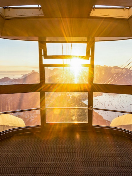 View of Rio de Janeiro from inside Sugar Loaf Mountain cable car at sunset.