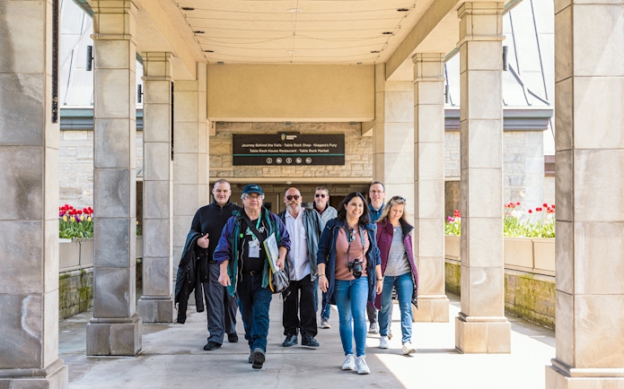 Tourists walking through a corridor towards Skylon Tower entrance.