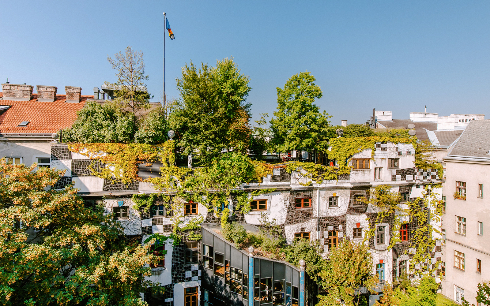 KUNST HAUS WIEN rooftop garden with lush greenery and colorful windows in Vienna.