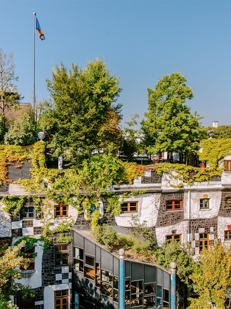 KUNST HAUS WIEN rooftop garden with lush greenery and colorful windows in Vienna.