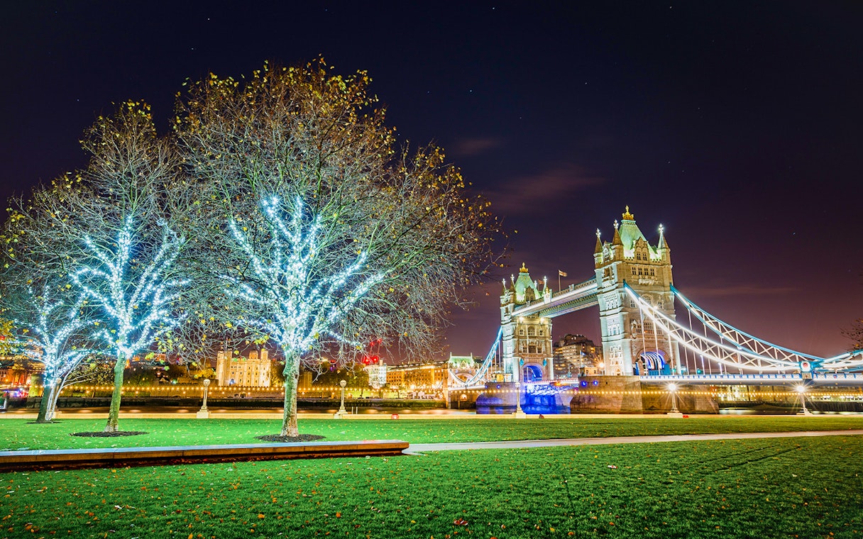 Tower Bridge illuminated at night with Christmas lights in London.