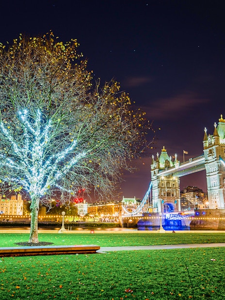 Tower Bridge illuminated at night with Christmas lights in London.
