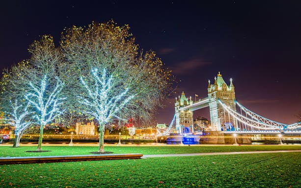Tower Bridge illuminated at night with Christmas lights in London.